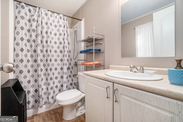 bathroom with vanity, hardwood / wood-style floors, a textured ceiling, and toilet