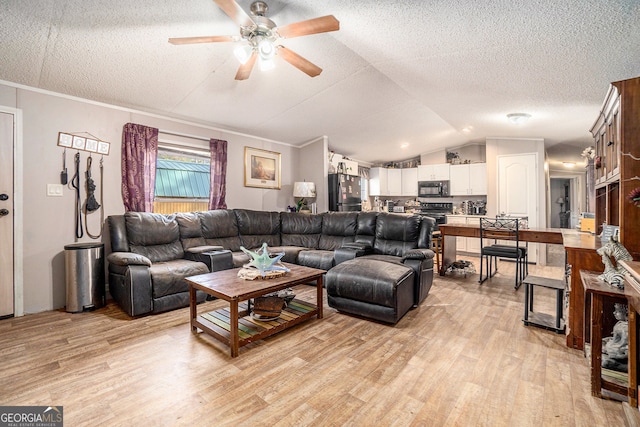 living room featuring a textured ceiling, light hardwood / wood-style flooring, vaulted ceiling, and ceiling fan