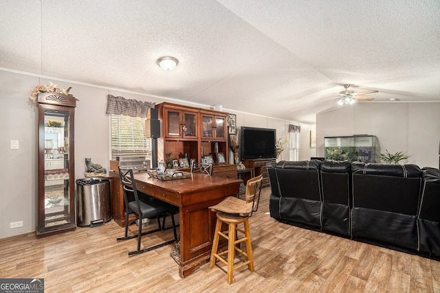 dining area featuring a textured ceiling, ceiling fan, light hardwood / wood-style flooring, and lofted ceiling