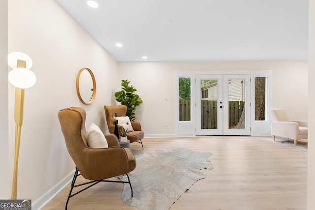 sitting room with light hardwood / wood-style flooring and french doors