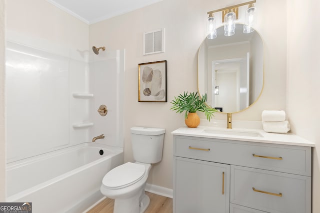 full bathroom featuring vanity, toilet, wood-type flooring, and ornamental molding