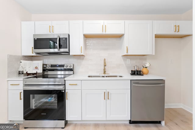 kitchen featuring white cabinetry, sink, and stainless steel appliances