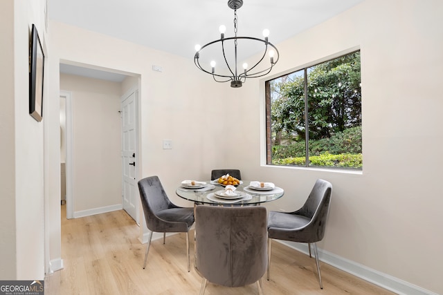 dining area featuring light hardwood / wood-style flooring and a notable chandelier