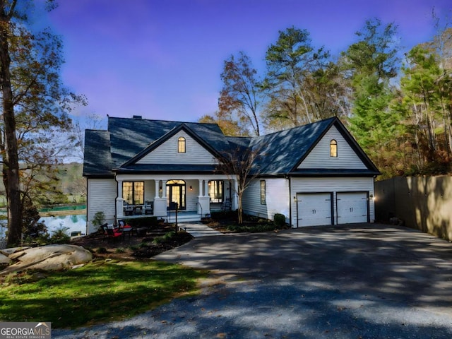 view of front facade with covered porch and a garage