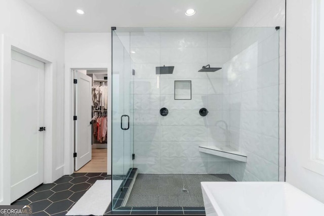 bathroom featuring tile patterned flooring and a shower with shower door