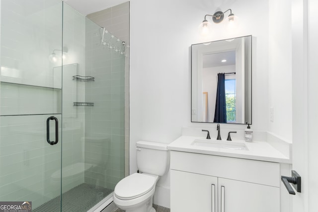 bathroom with vanity, an enclosed shower, and toilet