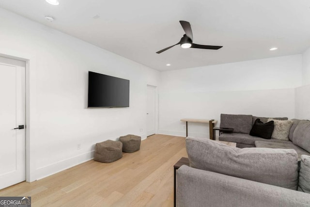 living room with hardwood / wood-style flooring and ceiling fan