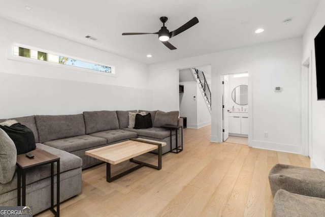 living room featuring ceiling fan and light wood-type flooring