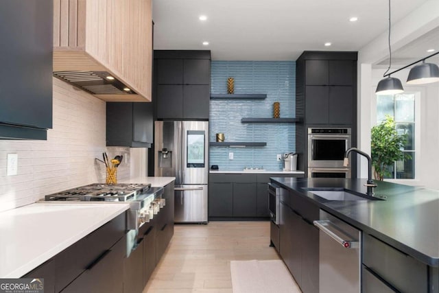 kitchen featuring decorative light fixtures, premium range hood, a wealth of natural light, and appliances with stainless steel finishes