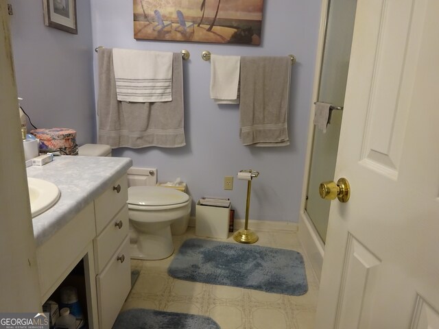 bathroom featuring vanity, toilet, and walk in shower