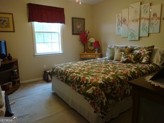 bedroom featuring light colored carpet