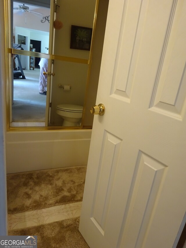 bathroom with ceiling fan and toilet