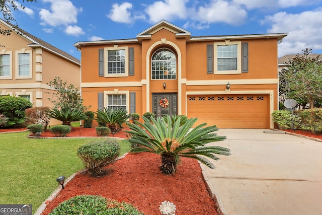 view of front facade with a front yard and a garage