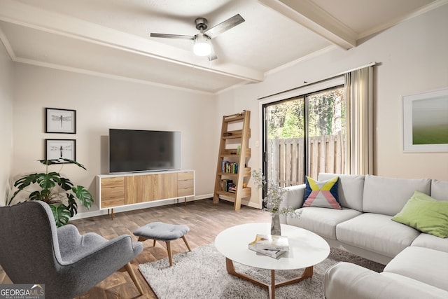 living room with ceiling fan, crown molding, beamed ceiling, and wood-type flooring