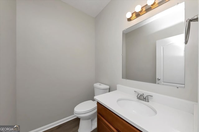 bathroom featuring hardwood / wood-style flooring, vanity, and toilet