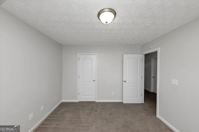 unfurnished bedroom with light carpet and a textured ceiling