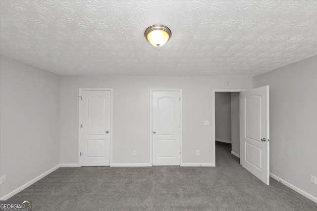 unfurnished bedroom featuring carpet and a textured ceiling