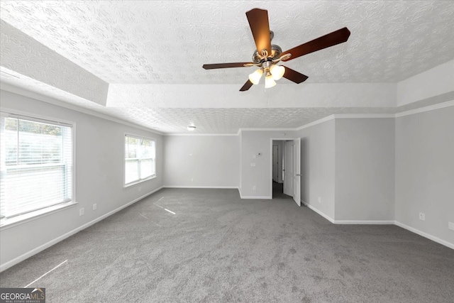 unfurnished room featuring ceiling fan, carpet, and a textured ceiling