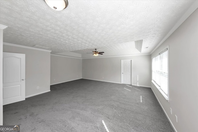 spare room featuring dark colored carpet, ceiling fan, and crown molding