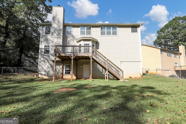 back of house with a lawn and a wooden deck