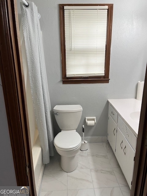 full bathroom featuring vanity, shower / tub combo, and toilet