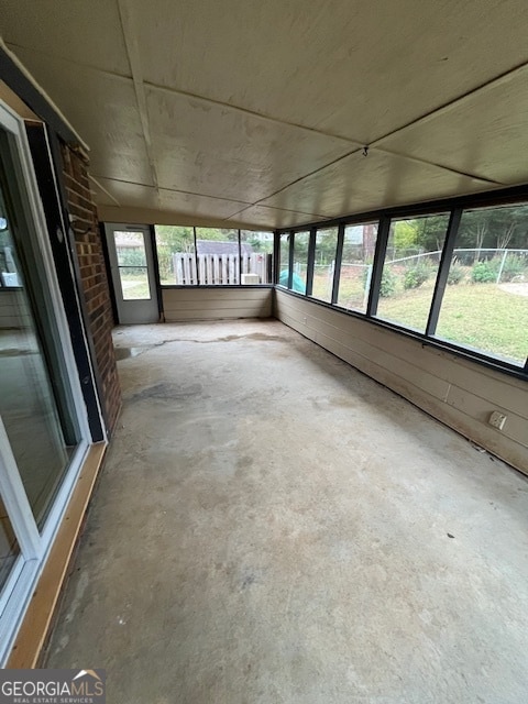 unfurnished sunroom featuring plenty of natural light