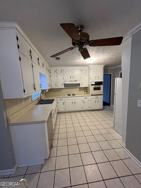 kitchen featuring sink, white cabinets, white appliances, and light tile patterned floors