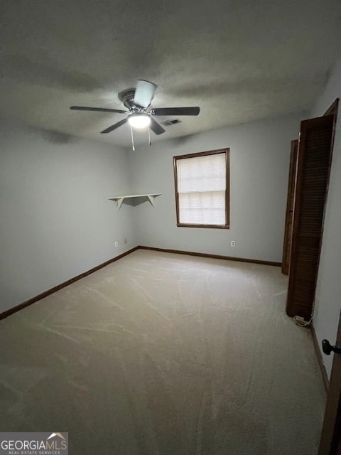 spare room featuring light colored carpet