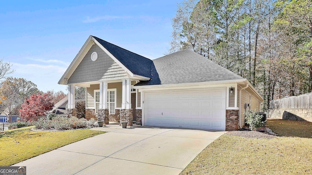 craftsman house featuring a garage and a front lawn