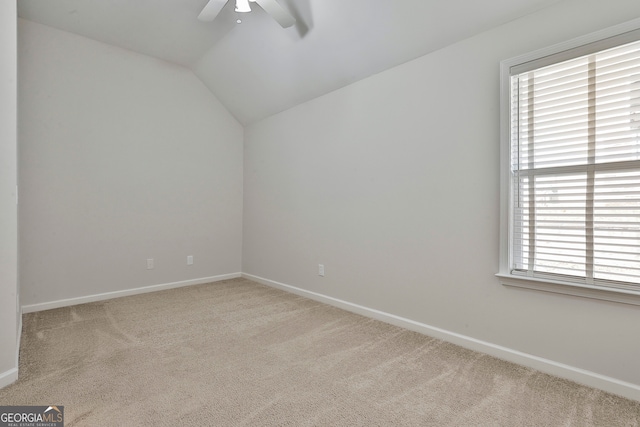 spare room with light carpet, ceiling fan, and lofted ceiling