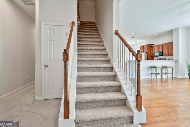 staircase featuring wood-type flooring