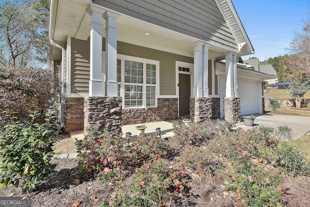 property entrance with a porch and a garage