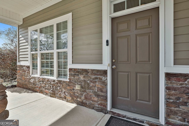 view of exterior entry with covered porch