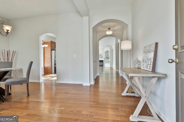 entryway featuring light hardwood / wood-style flooring and a notable chandelier