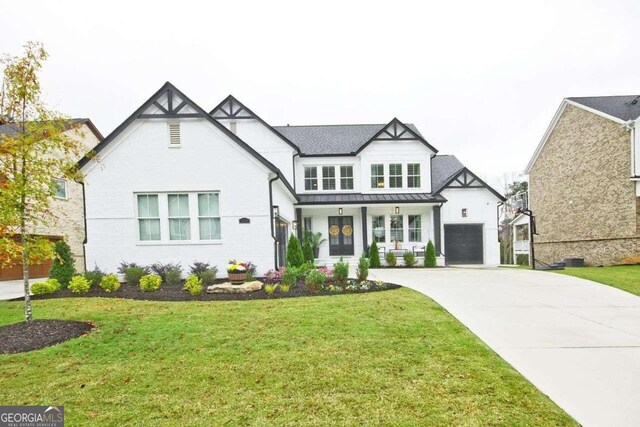 view of front of house with a front lawn, a porch, and a garage