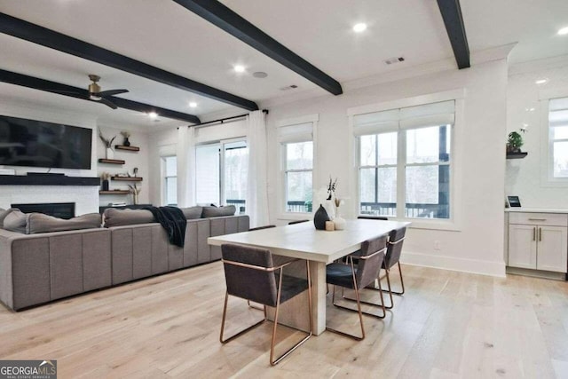 dining space with beamed ceiling, ceiling fan, light wood-type flooring, and ornamental molding