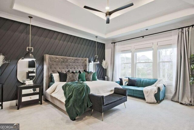 bedroom with carpet, ceiling fan, and wood walls