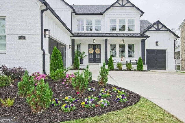 modern farmhouse style home featuring a porch and french doors