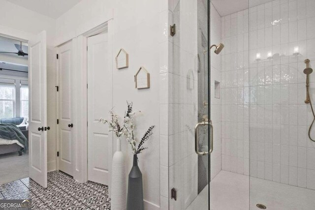 bathroom with tile patterned floors and a shower with shower door