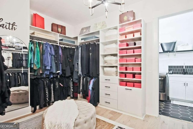 walk in closet with wood-type flooring