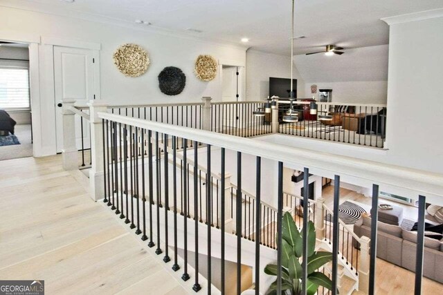 hall featuring light hardwood / wood-style floors and crown molding