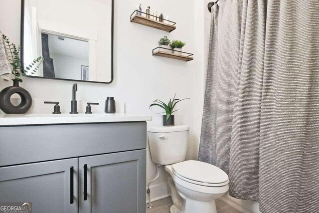 bathroom with tile patterned floors, vanity, and toilet