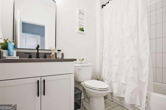 full bathroom with vanity, toilet, and shower / bath combo with shower curtain