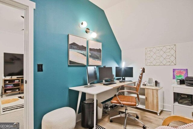 office space featuring light hardwood / wood-style flooring and lofted ceiling