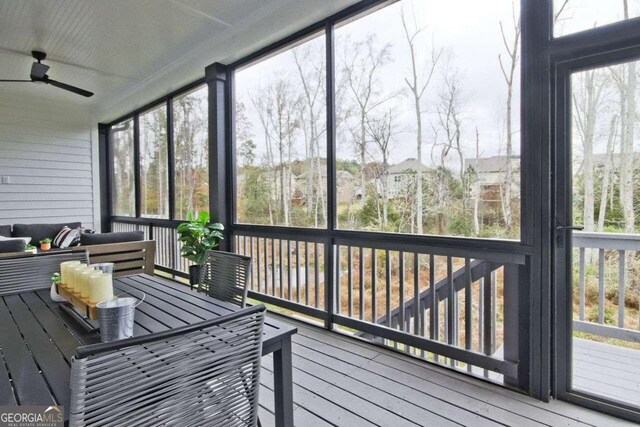 sunroom / solarium with ceiling fan and a healthy amount of sunlight