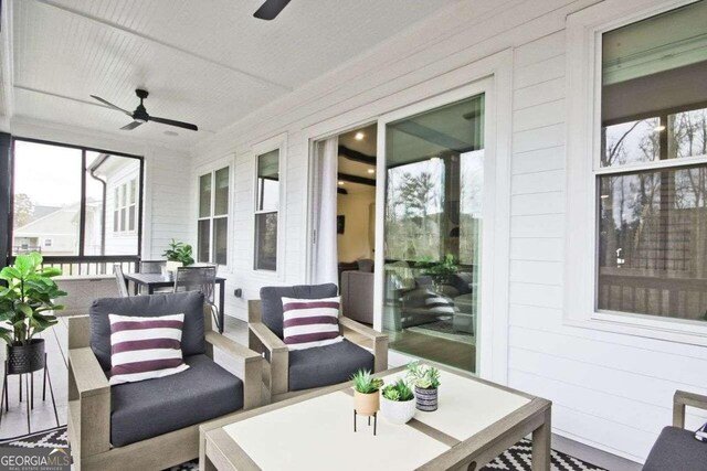 sunroom with a wealth of natural light and ceiling fan