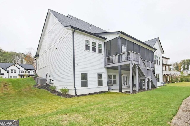 back of house with a lawn, a sunroom, a patio, and central AC unit