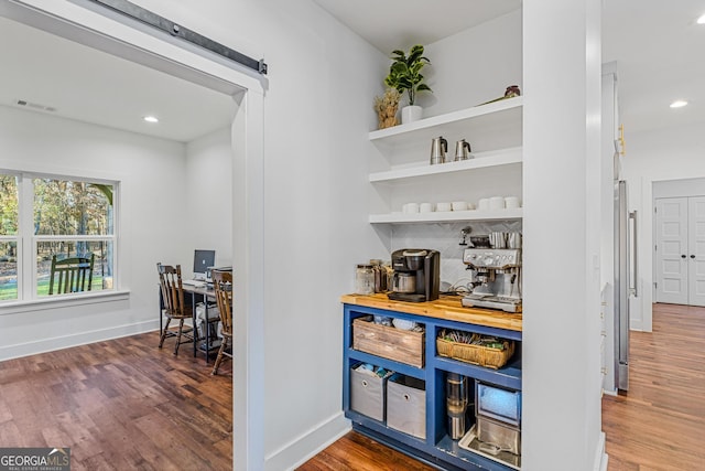 bar featuring tasteful backsplash and hardwood / wood-style flooring