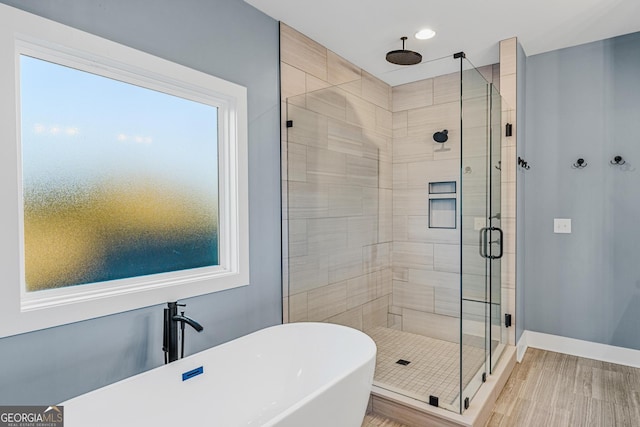 bathroom featuring hardwood / wood-style floors and shower with separate bathtub