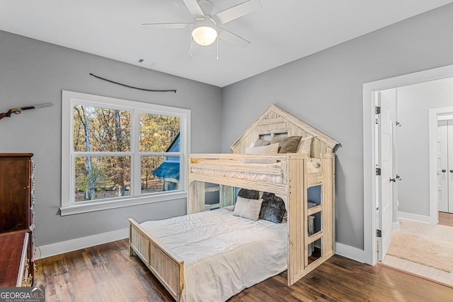 bedroom with dark hardwood / wood-style floors and ceiling fan